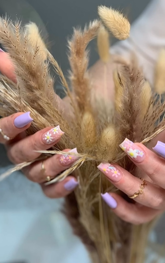 Close-up of lilac floral nail art hand-painted by Miria at Peaky Queen Beauty Salon